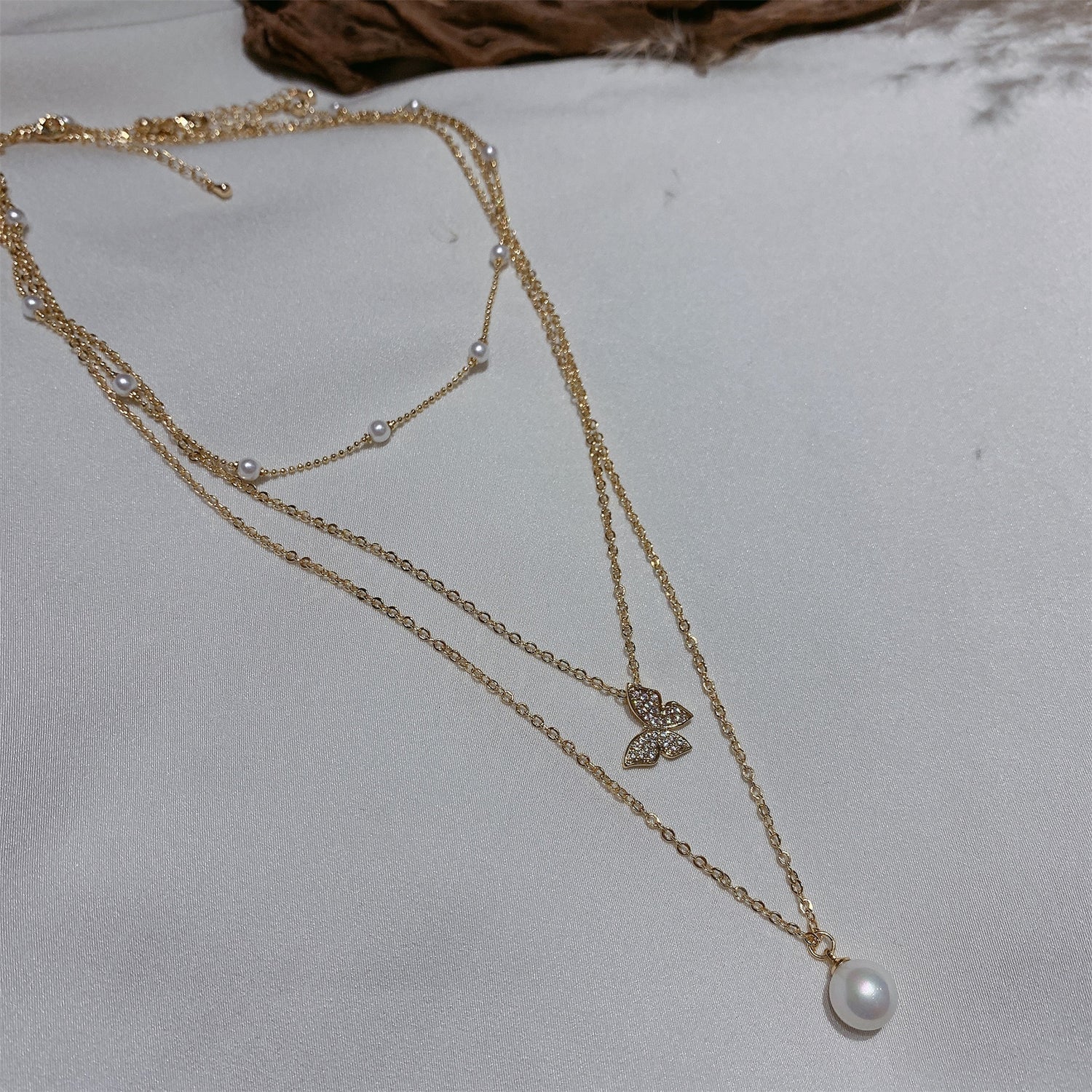 Multi-layered butterfly pearl necklace