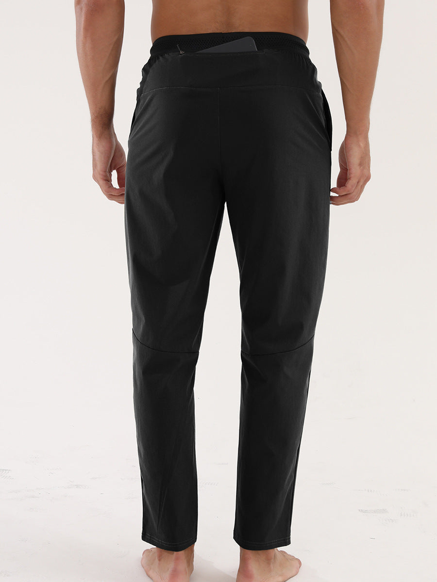 Men’s Thin Sports &amp; Leisure Running Pants worn by a man, showcasing the back view design and fit.