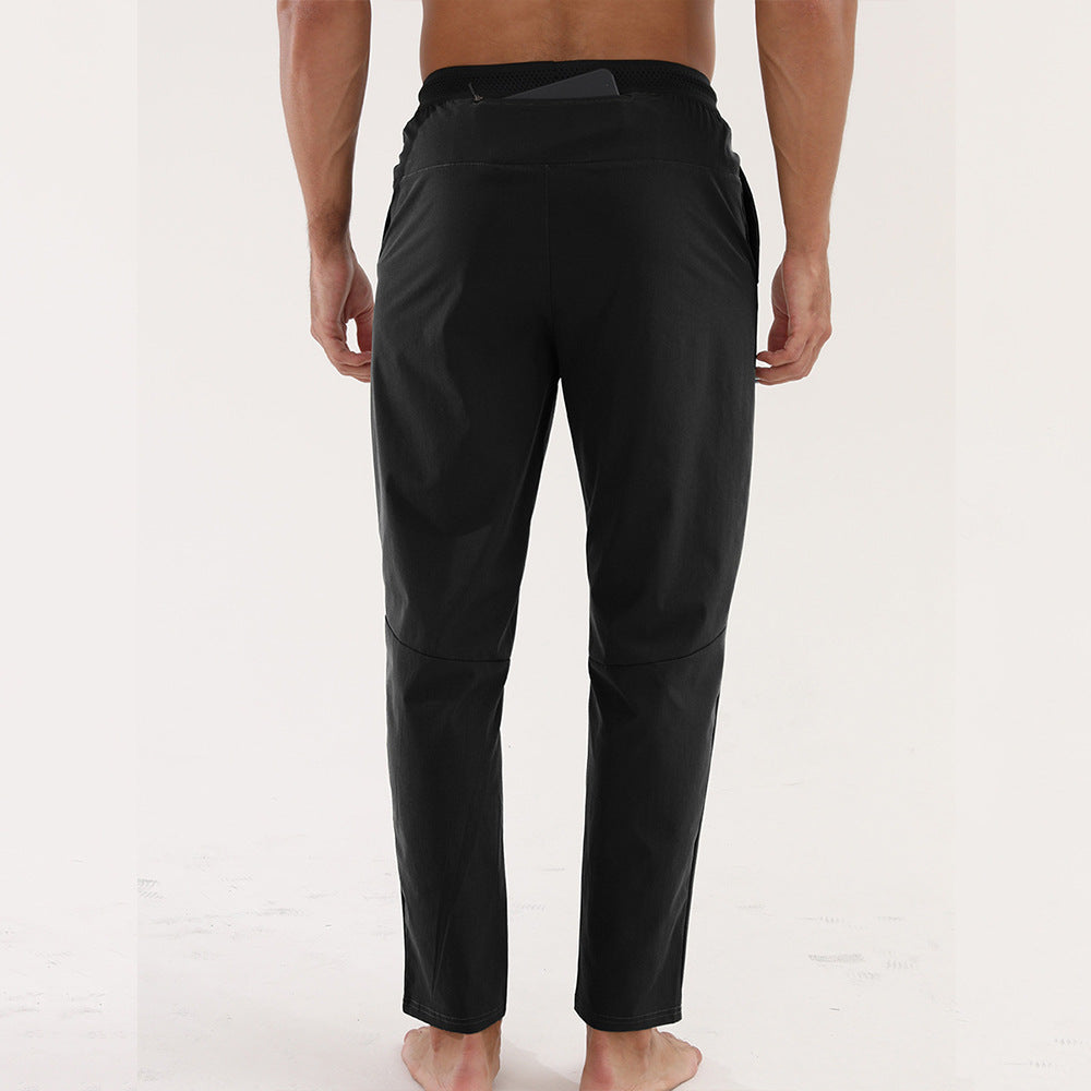 Men’s Thin Sports &amp; Leisure Running Pants showing the back view of a man wearing breathable fitness trousers.