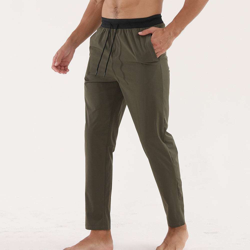 Men’s Thin Sports &amp; Leisure Running Pants in olive green, designed for comfort and breathability during workouts.
